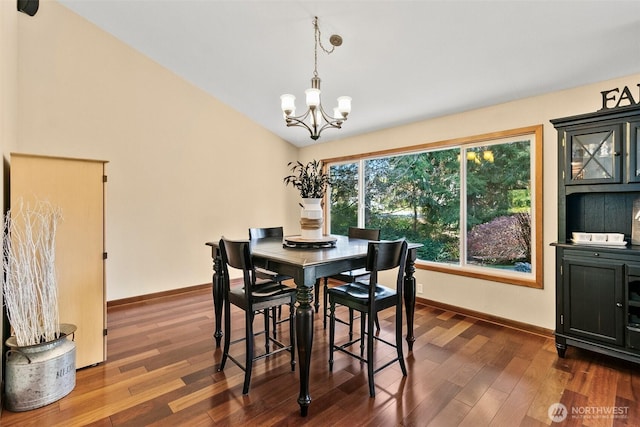 24264 133rd Ave SE, Kent, WA 98042 - dining area featuring dark wood finished floors, vaulted ceiling, baseboards, and an inviting chandelier
