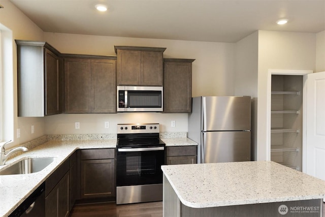 2306 158th Street Ct E, Tacoma, WA 98445 - kitchen featuring a sink, appliances with stainless steel finishes, dark wood-style floors, dark brown cabinets, and light stone counters