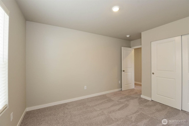 2306 158th Street Ct E, Tacoma, WA 98445 - unfurnished bedroom with a closet, baseboards, multiple windows, and light colored carpet