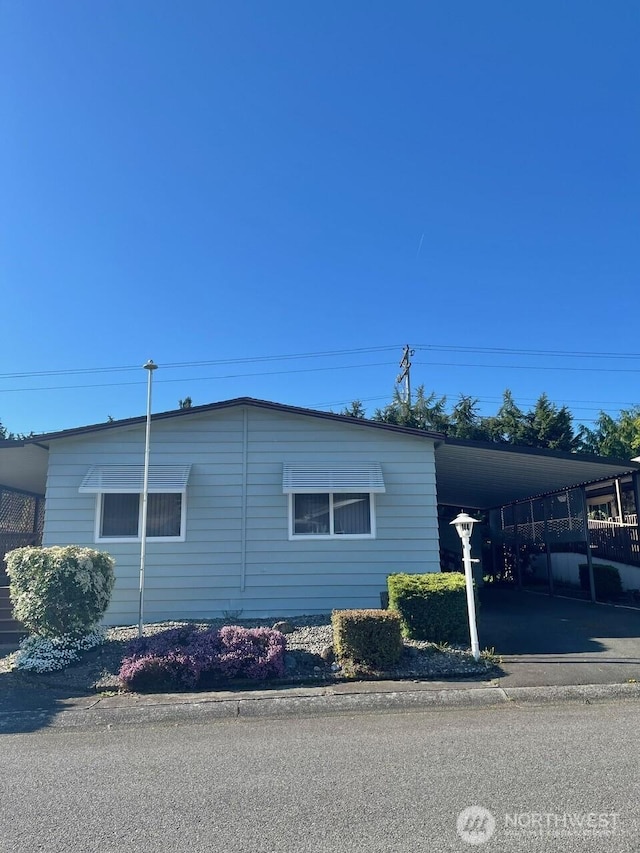 815 124th St SW Unit 144, Everett, WA 98204 - view of side of home with aphalt driveway and a carport