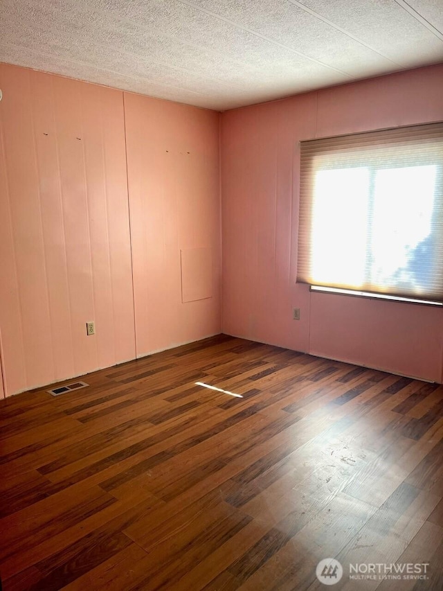 815 124th St SW Unit 144, Everett, WA 98204 - spare room with wood finished floors, visible vents, and a textured ceiling