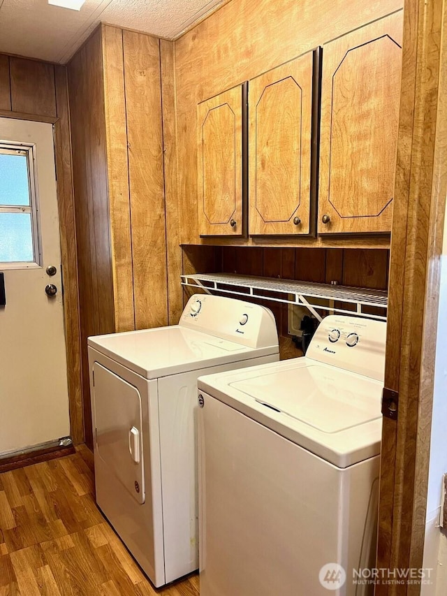 815 124th St SW Unit 144, Everett, WA 98204 - washroom with separate washer and dryer, cabinet space, and light wood-style flooring