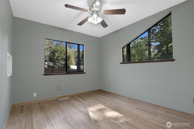 5350 Aspinwall Ct NW, Olympia, WA 98502 - unfurnished room with hardwood / wood-style flooring, a ceiling fan, and baseboards