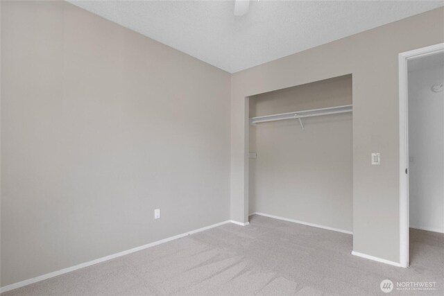 5350 Aspinwall Ct NW, Olympia, WA 98502 - unfurnished bedroom with baseboards, carpet flooring, a closet, and a ceiling fan