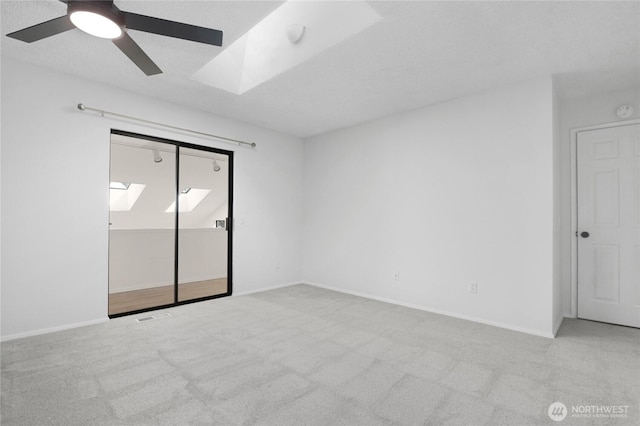 5350 Aspinwall Ct NW, Olympia, WA 98502 - empty room with carpet, a skylight, ceiling fan, and baseboards
