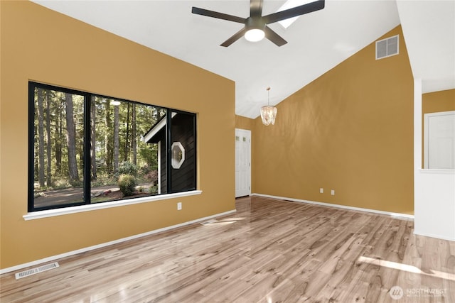5350 Aspinwall Ct NW, Olympia, WA 98502 - unfurnished living room featuring high vaulted ceiling, ceiling fan, wood finished floors, a chandelier, and baseboards