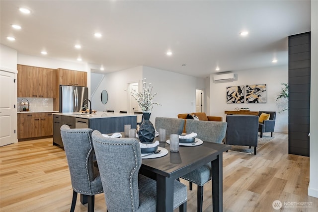 710 E 5th St, Nooksack, WA 98276 - dining room with light wood-style floors, recessed lighting, and a wall mounted AC