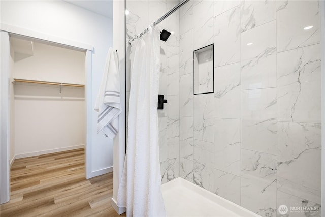 710 E 5th St, Nooksack, WA 98276 - bathroom with a walk in closet, baseboards, a shower stall, and wood finished floors