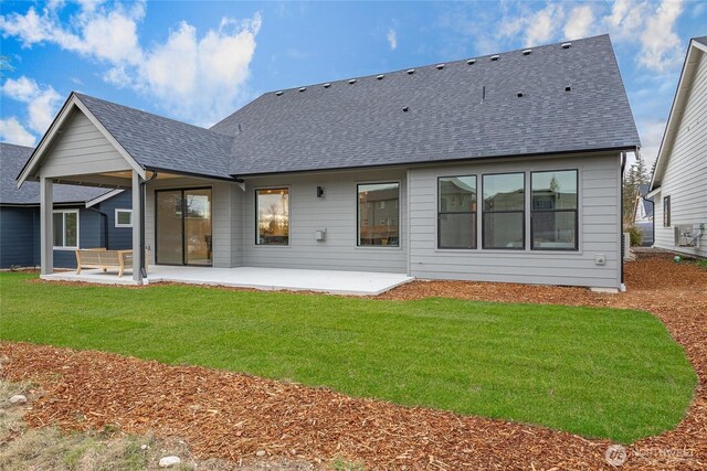 710 E 5th St, Nooksack, WA 98276 - back of house featuring a lawn, a shingled roof, and a patio area