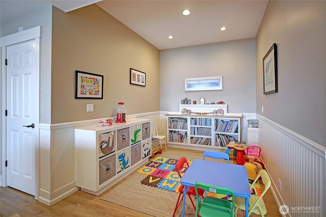 playroom with recessed lighting, light wood-style floors, and a wainscoted wall