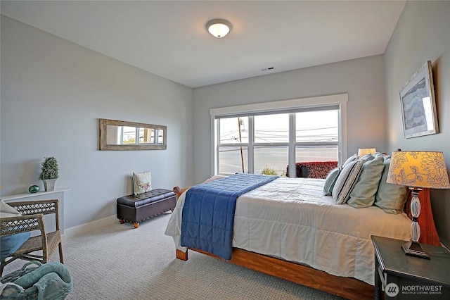 carpeted bedroom with baseboards and visible vents