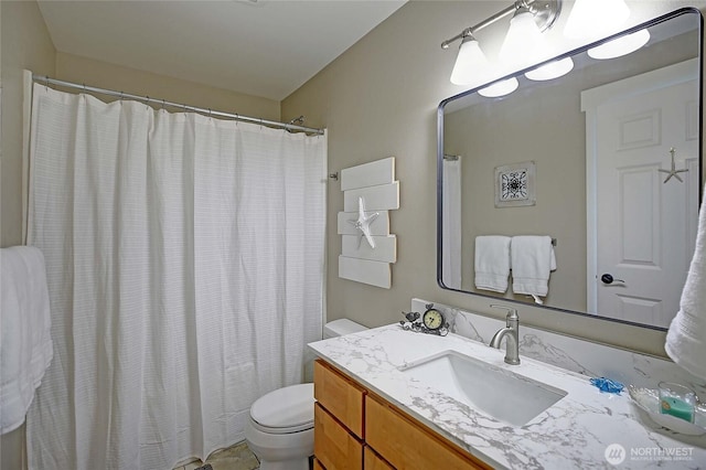 bathroom featuring toilet and vanity