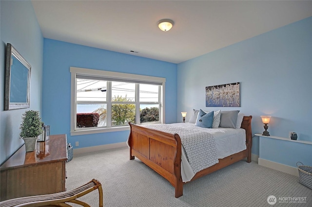bedroom featuring light carpet, baseboards, and visible vents