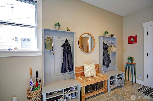 mudroom with baseboards and stone finish floor