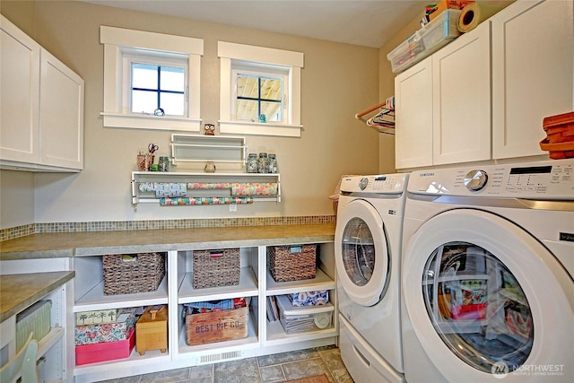 clothes washing area with washing machine and clothes dryer and cabinet space