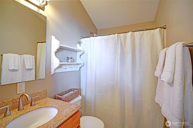full bathroom featuring vanity, curtained shower, and toilet