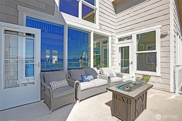 view of patio / terrace featuring an outdoor living space with a fire pit