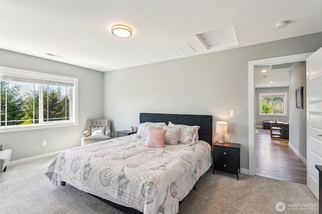 carpeted bedroom featuring visible vents and baseboards