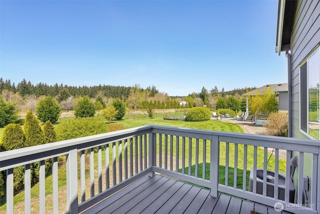 wooden terrace with a yard and central AC unit