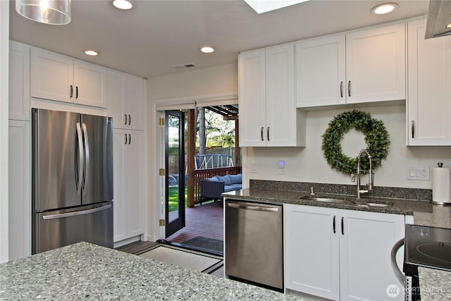 21221 SE 271st Pl, Maple Valley, WA 98038 - kitchen with dark stone countertops, visible vents, a sink, appliances with stainless steel finishes, and white cabinetry