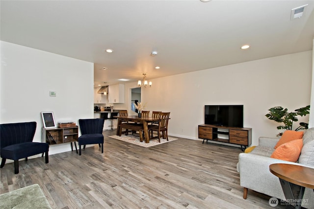 21221 SE 271st Pl, Maple Valley, WA 98038 - living room with recessed lighting, visible vents, light wood-type flooring, and an inviting chandelier