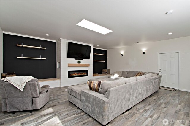 21221 SE 271st Pl, Maple Valley, WA 98038 - living room with light wood-type flooring, a large fireplace, and recessed lighting