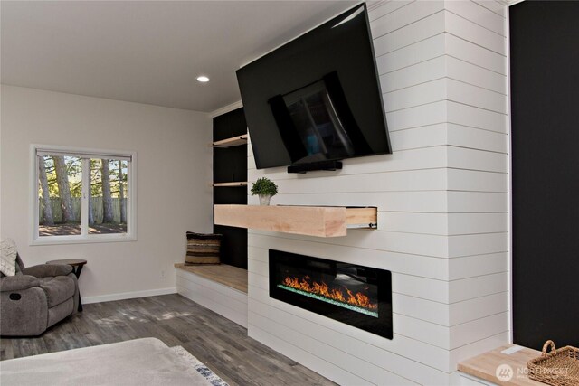 21221 SE 271st Pl, Maple Valley, WA 98038 - unfurnished living room featuring baseboards, recessed lighting, a glass covered fireplace, and dark wood finished floors
