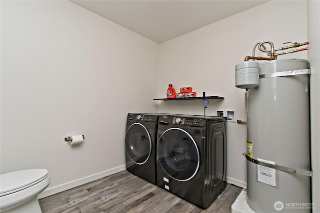 21221 SE 271st Pl, Maple Valley, WA 98038 - laundry room with baseboards, laundry area, wood finished floors, water heater, and washing machine and clothes dryer