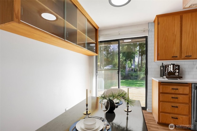 interior space with light wood finished floors and beverage cooler