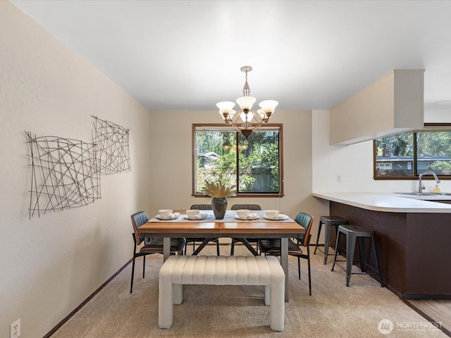 8142 NE 145th Pl, Kenmore, WA 98028 - dining area featuring light carpet, baseboards, and a chandelier