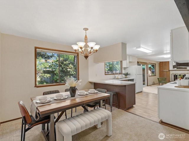 8142 NE 145th Pl, Kenmore, WA 98028 - dining space with an inviting chandelier and a lit fireplace