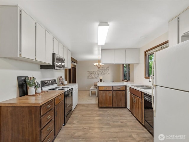 8142 NE 145th Pl, Kenmore, WA 98028 - kitchen with light wood finished floors, stainless steel microwave, electric range, freestanding refrigerator, and black dishwasher