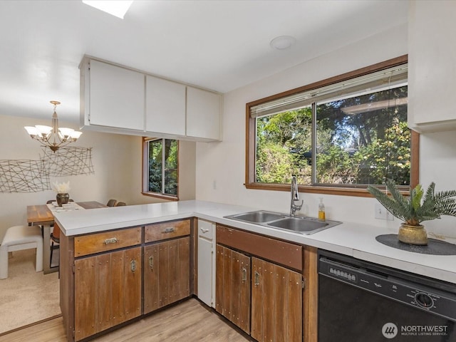 8142 NE 145th Pl, Kenmore, WA 98028 - kitchen featuring an inviting chandelier, light countertops, dishwasher, a sink, and a peninsula