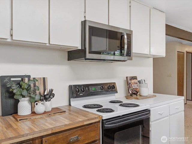 8142 NE 145th Pl, Kenmore, WA 98028 - kitchen featuring range with electric stovetop, wood counters, stainless steel microwave, and white cabinetry