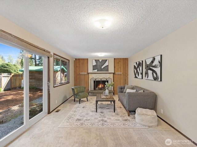 8142 NE 145th Pl, Kenmore, WA 98028 - living area featuring plenty of natural light, a fireplace, a textured ceiling, and carpet