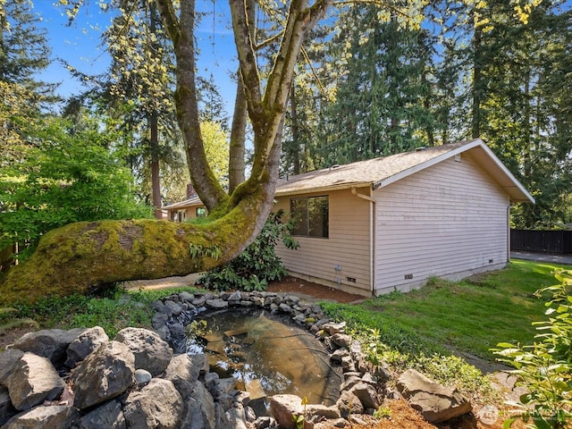 8142 NE 145th Pl, Kenmore, WA 98028 - view of side of property with fence, crawl space, a yard, and a small pond