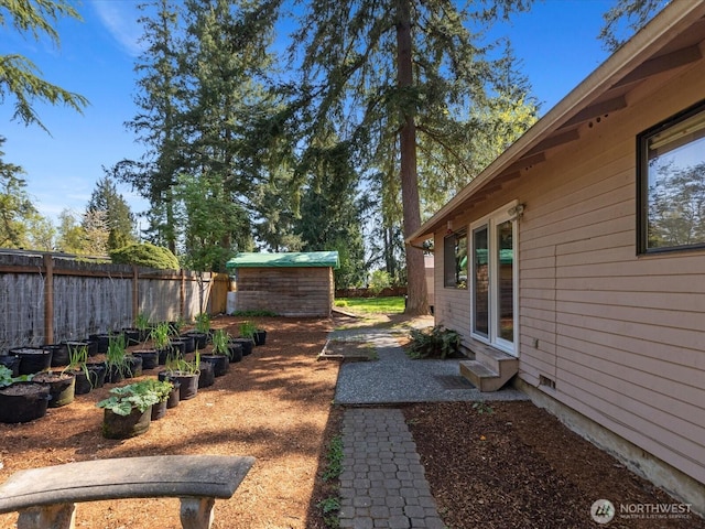 8142 NE 145th Pl, Kenmore, WA 98028 - view of yard with a storage shed, entry steps, an outbuilding, and fence