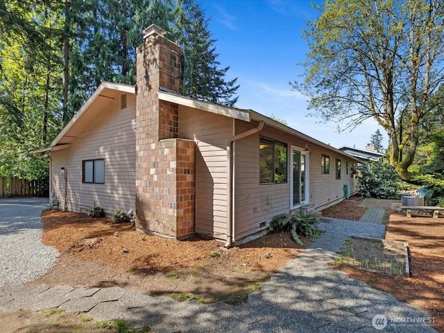 8142 NE 145th Pl, Kenmore, WA 98028 - view of side of property featuring fence and a chimney