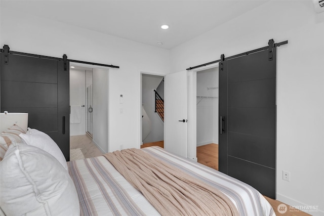 431 19th Ave E, Seattle, WA 98112 - bedroom featuring a barn door, recessed lighting, a walk in closet, and a closet