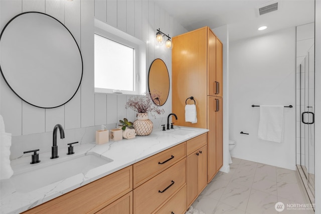 431 19th Ave E, Seattle, WA 98112 - full bathroom featuring toilet, a shower stall, marble finish floors, and double vanity