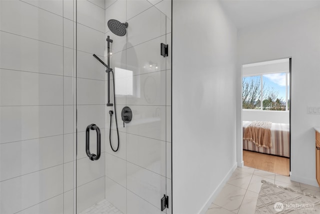 431 19th Ave E, Seattle, WA 98112 - ensuite bathroom featuring a stall shower, baseboards, and marble look tile flooring
