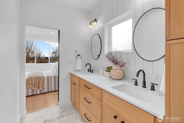 431 19th Ave E, Seattle, WA 98112 - full bath featuring marble finish flooring, double vanity, and baseboards