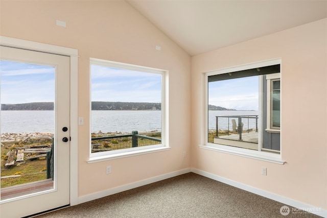 840 Beckett Point Rd, Port Townsend, WA 98368 - carpeted empty room featuring a water view, vaulted ceiling, and a healthy amount of sunlight