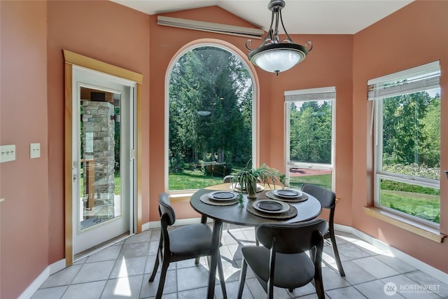 dining space with plenty of natural light, baseboards, and light tile patterned floors