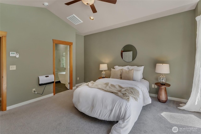 carpeted bedroom featuring connected bathroom, baseboards, heating unit, lofted ceiling, and visible vents