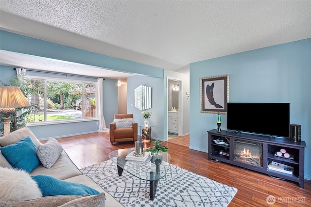 2336 Killarney Ct NW, Olympia, WA 98502 - living area featuring a textured ceiling, wood finished floors, and baseboards