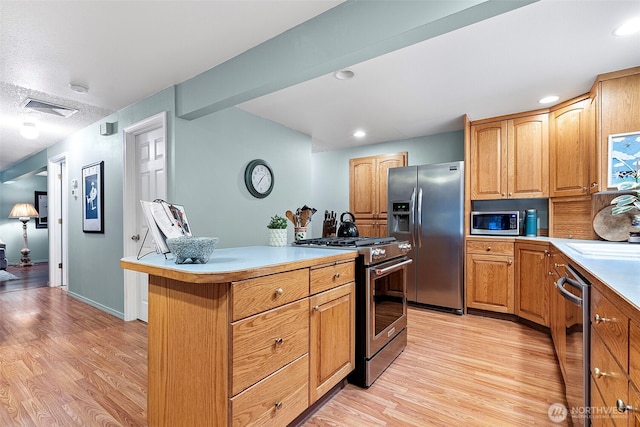 2336 Killarney Ct NW, Olympia, WA 98502 - kitchen featuring light countertops, light wood-style flooring, appliances with stainless steel finishes, and visible vents