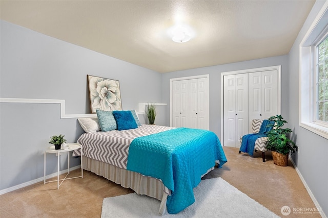 2336 Killarney Ct NW, Olympia, WA 98502 - carpeted bedroom featuring baseboards, multiple windows, and two closets