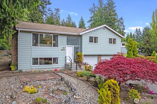 raised ranch featuring an attached garage