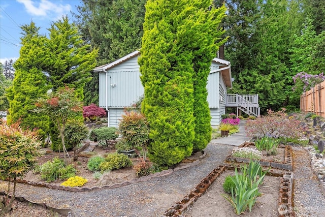 view of yard with fence and stairs
